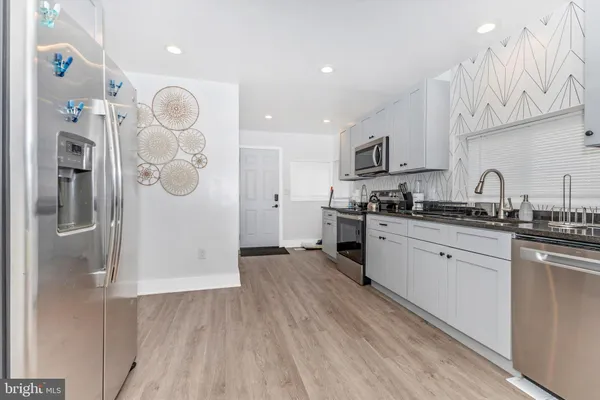 a kitchen with cabinets and stainless steel appliances