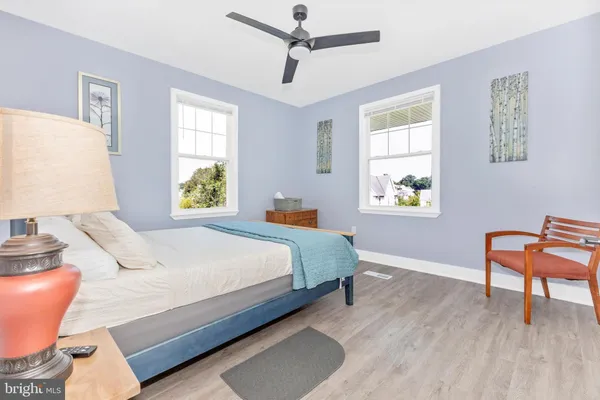 a bedroom with a bed and a chair