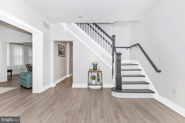 a view of entryway and hall with wooden floor