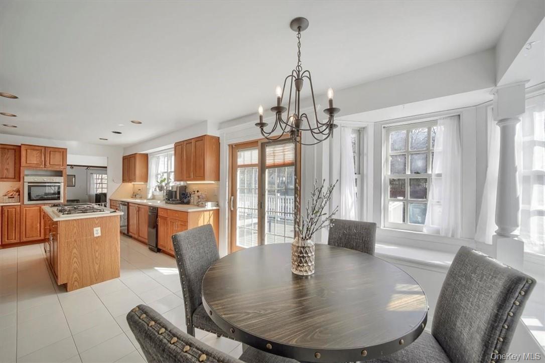 10 High Tor Road New City, NY 10956 - Photo 11 of 33 a dining room with furniture a chandelier and wooden floor