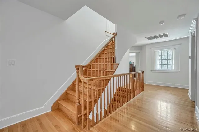 a view of entryway and hall with wooden floor