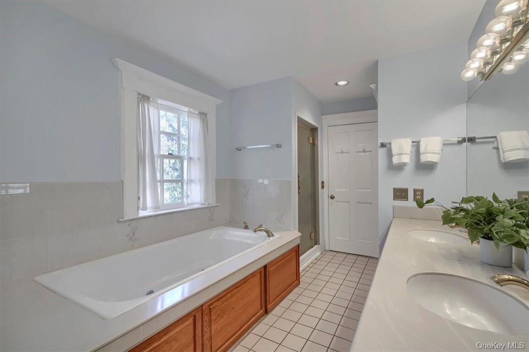 10 High Tor Road New City, NY 10956 - Photo 17 of 33 a spacious bathroom with a granite countertop tub sink and mirror