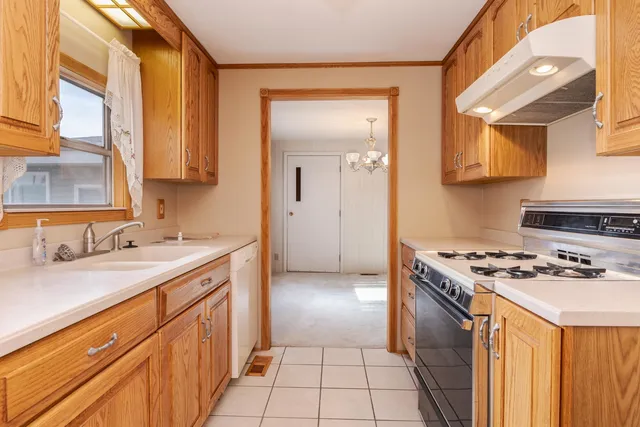 a kitchen with stainless steel appliances granite countertop a stove and a refrigerator
