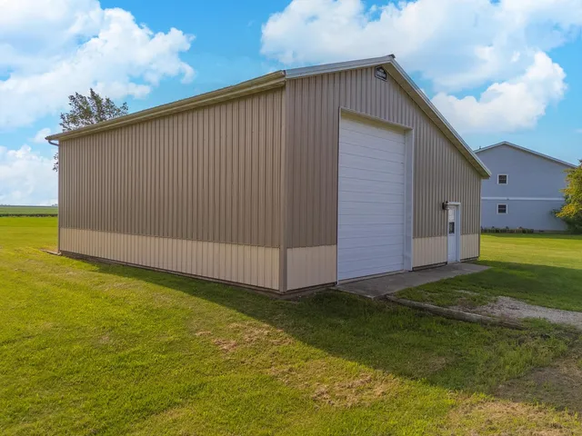a house that is sitting in a yard with large trees