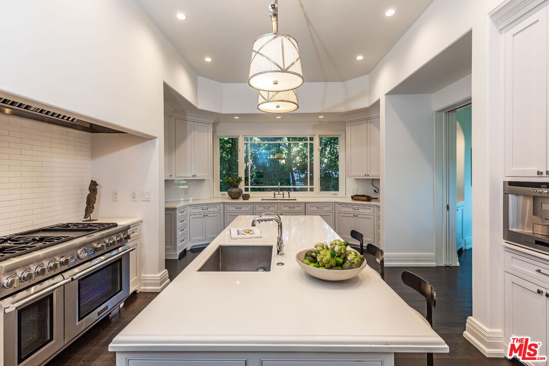 8 Oakmont Drive Los Angeles, CA 90049 - Photo 15 of 46 a kitchen with stove and white cabinets
