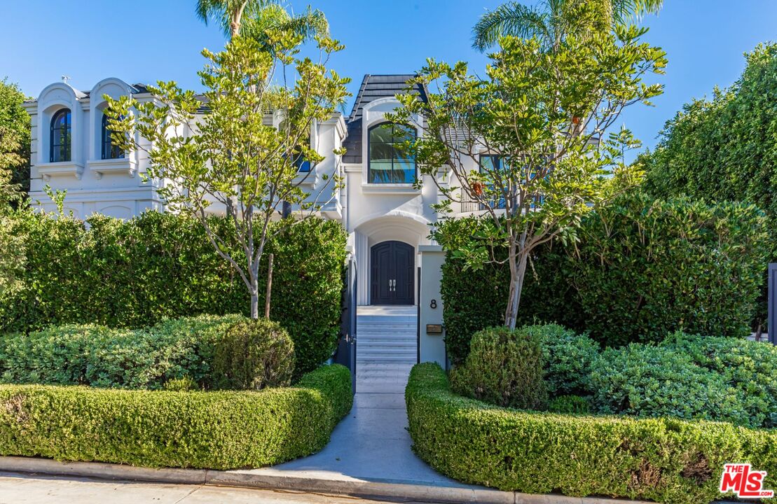 8 Oakmont Drive Los Angeles, CA 90049 - Photo 2 of 46 a front view of a house with a yard and potted plants
