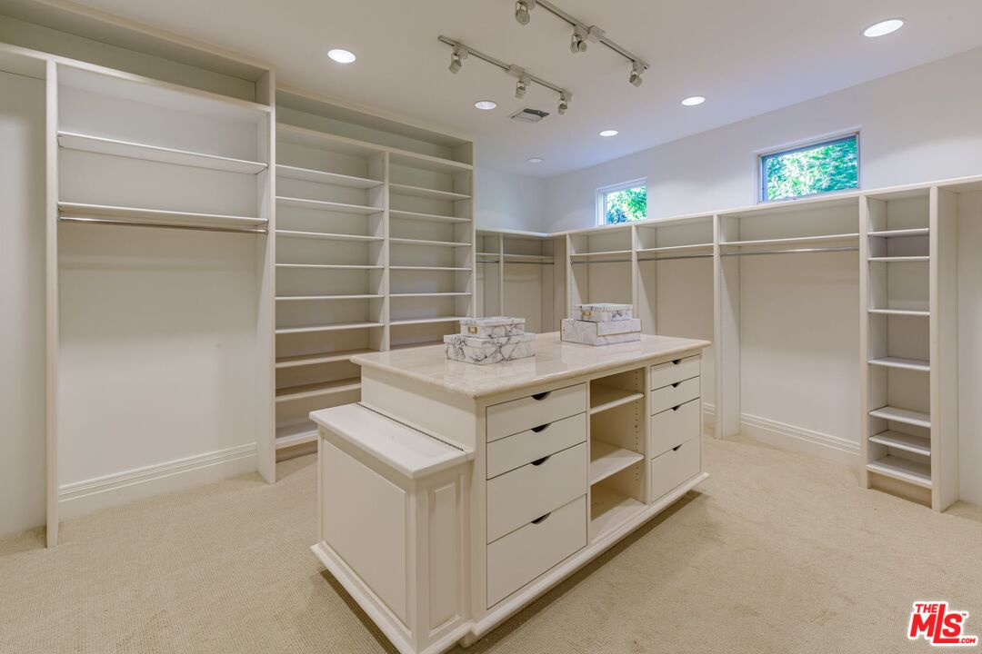 8 Oakmont Drive Los Angeles, CA 90049 - Photo 25 of 46 a bathroom with a sink mirror and a shower
