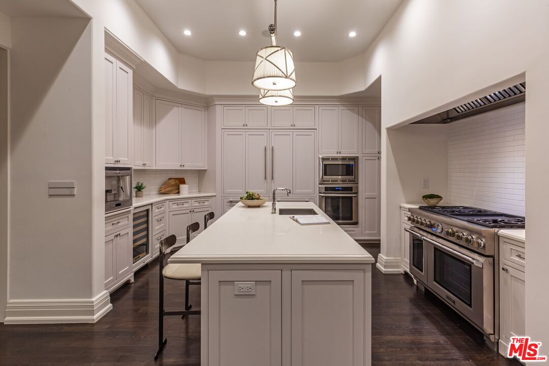 8 Oakmont Drive Los Angeles, CA 90049 - Photo 41 of 46 a kitchen with a stove a sink and a refrigerator