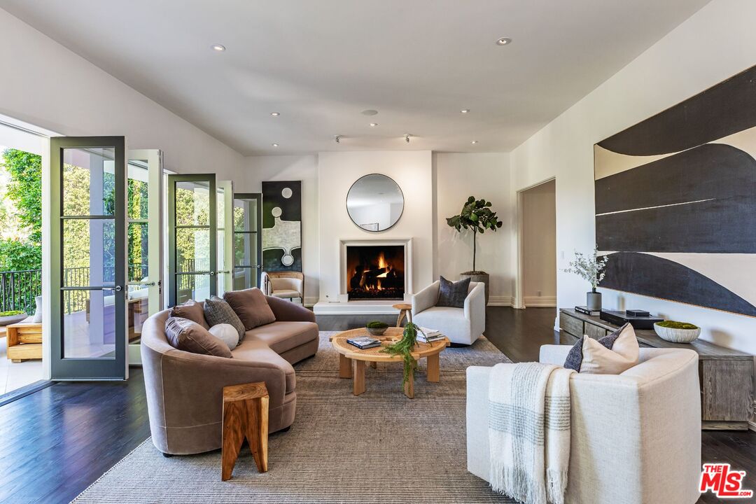 8 Oakmont Drive Los Angeles, CA 90049 - Photo 10 of 46 a living room with furniture and a fireplace