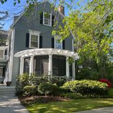 a front view of house with a garden