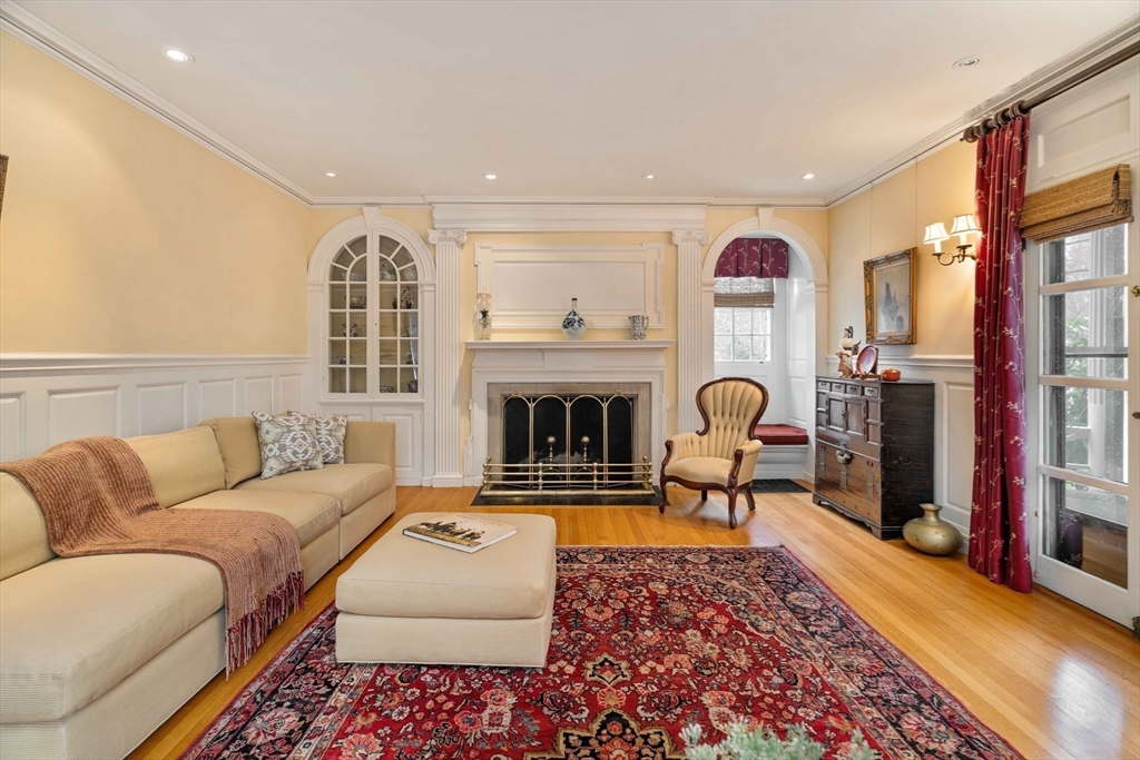 285 Clinton Road Brookline, MA 02245 - Photo 11 of 28 a living room with furniture a rug and a fireplace