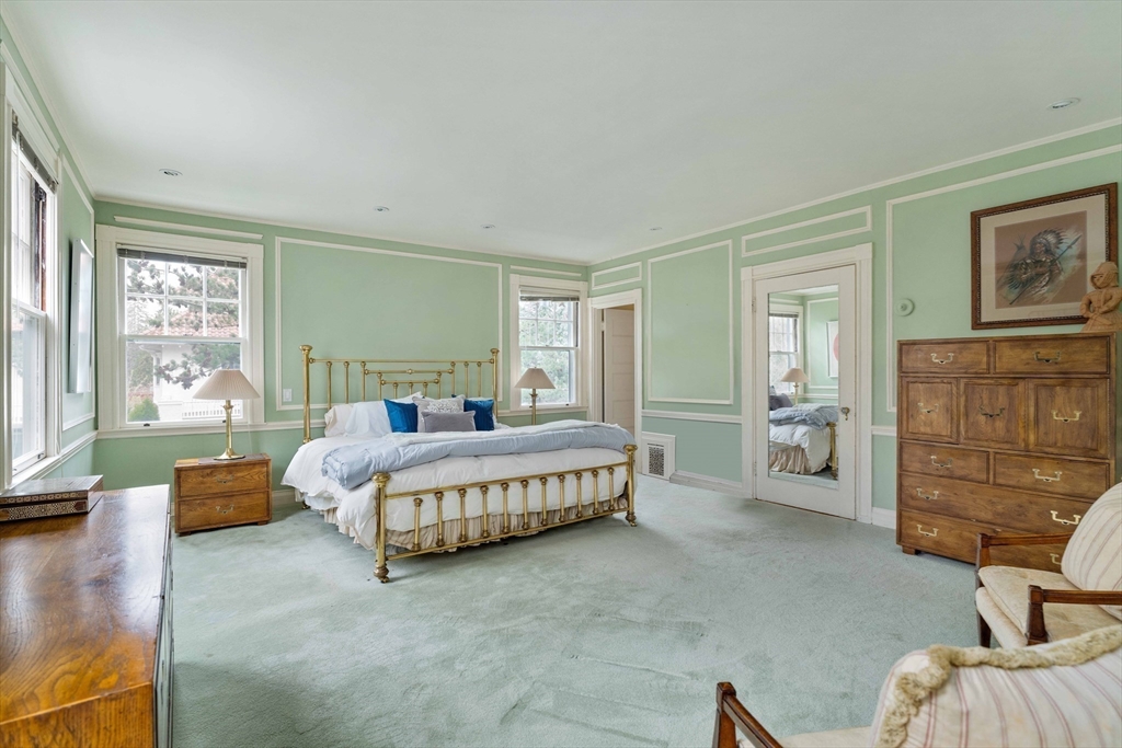 285 Clinton Road Brookline, MA 02245 - Photo 16 of 28 a spacious bedroom with a bed and a couch