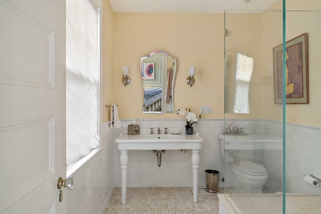285 Clinton Road Brookline, MA 02245 - Photo 17 of 28 a bathroom with a sink vanity and mirror