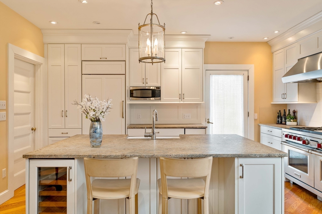 285 Clinton Road Brookline, MA 02245 - Photo 2 of 28 a kitchen with stainless steel appliances granite countertop a sink a stove and a refrigerator