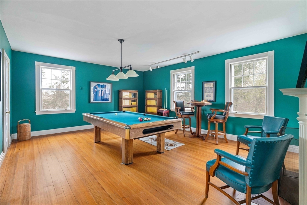 285 Clinton Road Brookline, MA 02245 - Photo 24 of 28 a living room with furniture a window and wooden floor