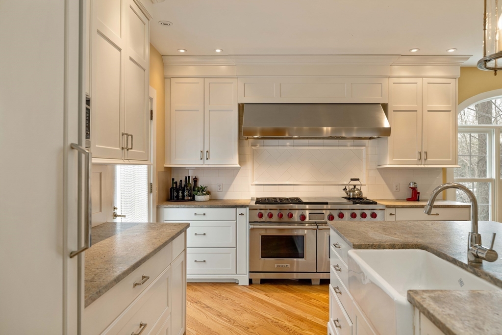 285 Clinton Road Brookline, MA 02245 - Photo 3 of 28 a kitchen with stainless steel appliances granite countertop a sink stove and refrigerator