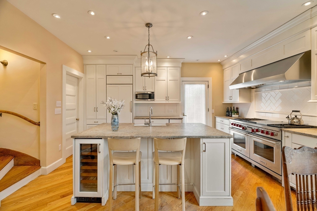 285 Clinton Road Brookline, MA 02245 - Photo 5 of 28 a large kitchen with stainless steel appliances granite countertop a stove and a refrigerator