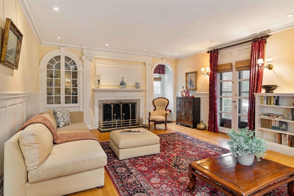 285 Clinton Road Brookline, MA 02245 - Photo 10 of 28 a living room with furniture a fireplace and a table
