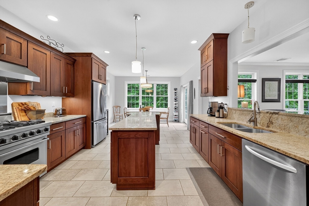176 Silver Street Granville, MA 01034 - Photo 19 of 40 a large kitchen with stainless steel appliances granite countertop a stove top oven a sink dishwasher a dining table and chairs
