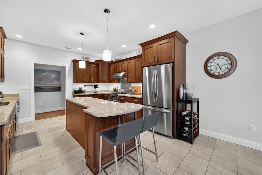 176 Silver Street Granville, MA 01034 - Photo 20 of 40 a kitchen with stainless steel appliances granite countertop a refrigerator a stove a sink and a dining table with wooden cabinet