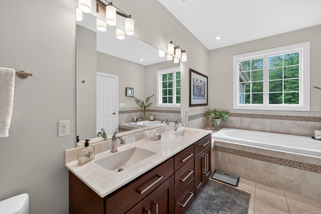 176 Silver Street Granville, MA 01034 - Photo 30 of 40 a bathroom with a sink double vanity and a bathtub
