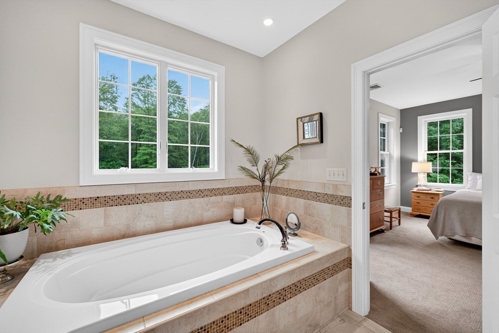 176 Silver Street Granville, MA 01034 - Photo 31 of 40 a white bath tub sitting next to a window