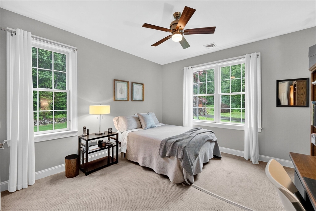 176 Silver Street Granville, MA 01034 - Photo 32 of 40 a bedroom with a bed a couch and a window