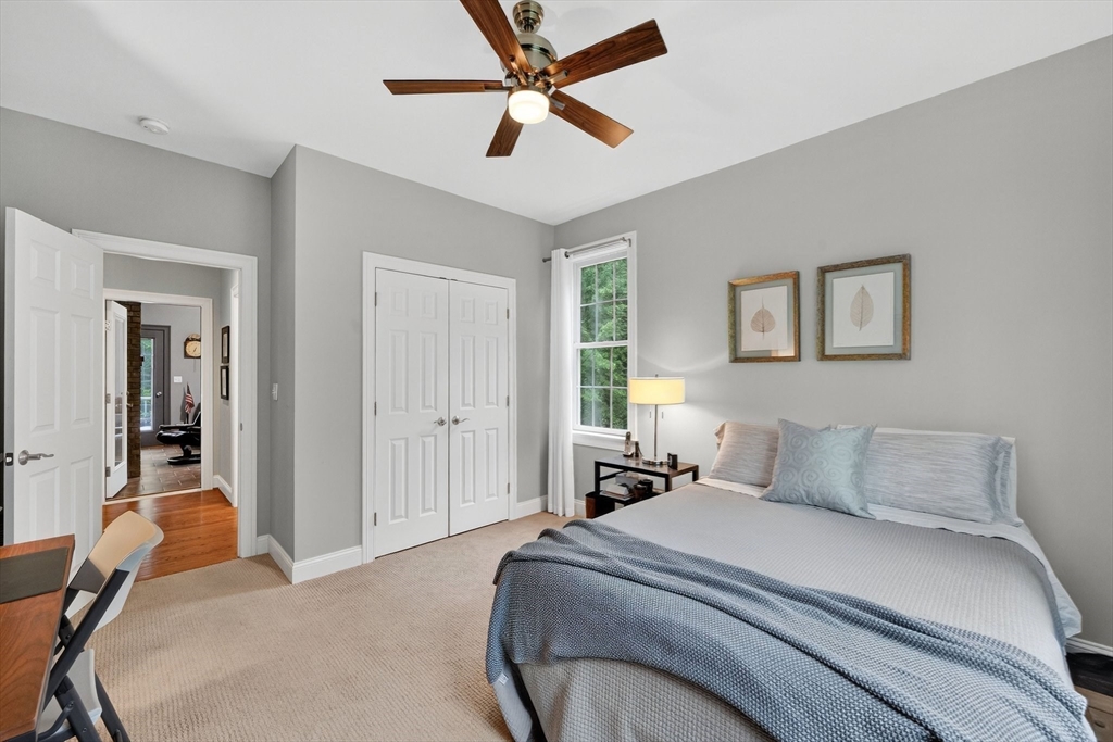 176 Silver Street Granville, MA 01034 - Photo 33 of 40 a bedroom with a bed and a chandelier