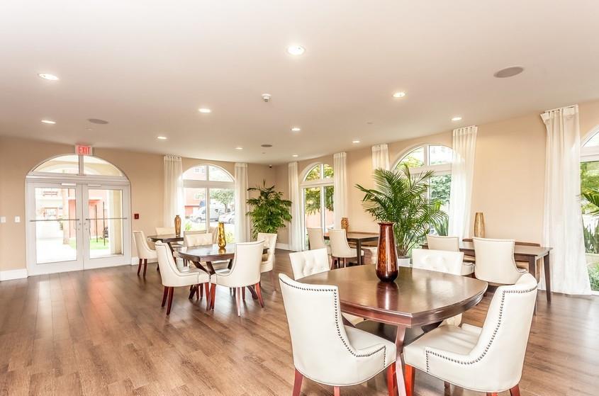 9357 Southwest 77th Avenue, Unit 25245 Miami, FL 33156 - Photo 17 of 20 a dining room with furniture potted plants and wooden floor