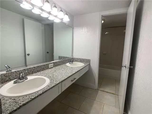 a bathroom with a sink double vanity and a mirror