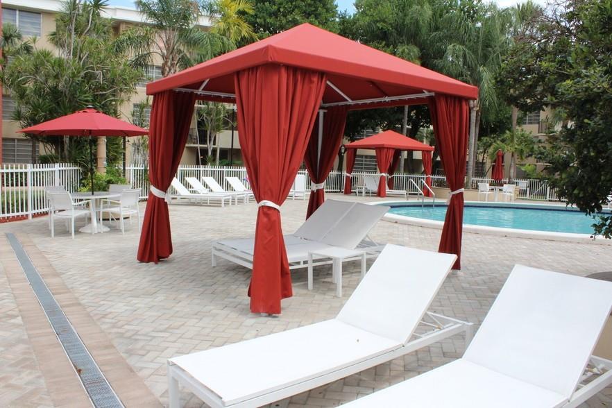 9357 Southwest 77th Avenue, Unit 25245 Miami, FL 33156 - Photo 10 of 20 an outdoor space with furniture and umbrella