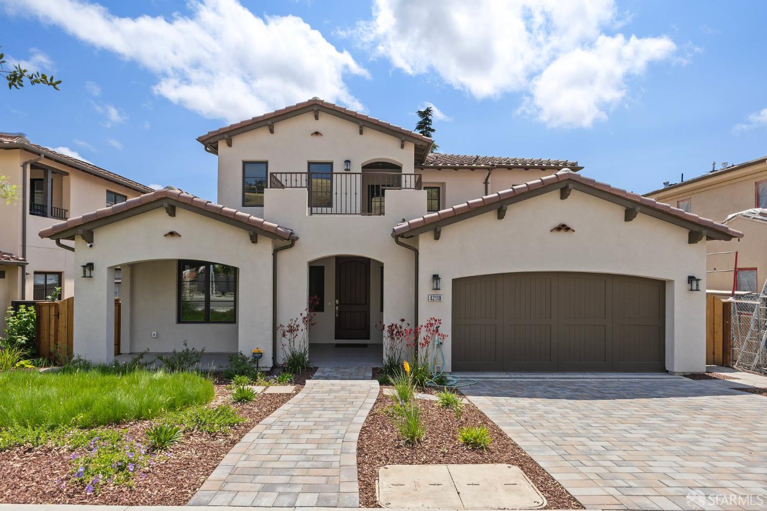 42119 Vinha Way Fremont, CA 94539 - Photo 1 of 43 a front view of a house with a yard and garage
