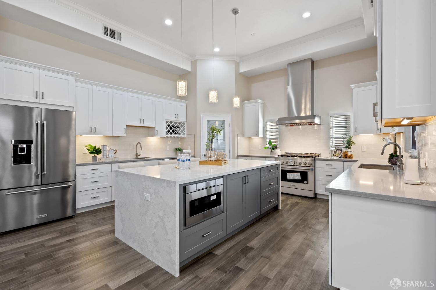 42119 Vinha Way Fremont, CA 94539 - Photo 13 of 43 a kitchen with stainless steel appliances granite countertop a white cabinets a sink a stove a refrigerator and island