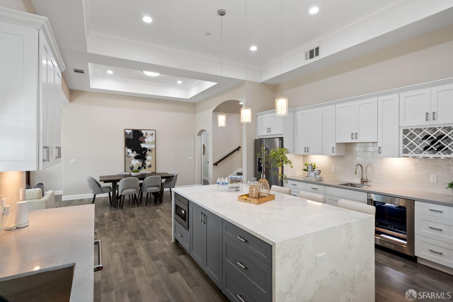 42119 Vinha Way Fremont, CA 94539 - Photo 14 of 43 a kitchen with a sink a stove and chairs with wooden floor