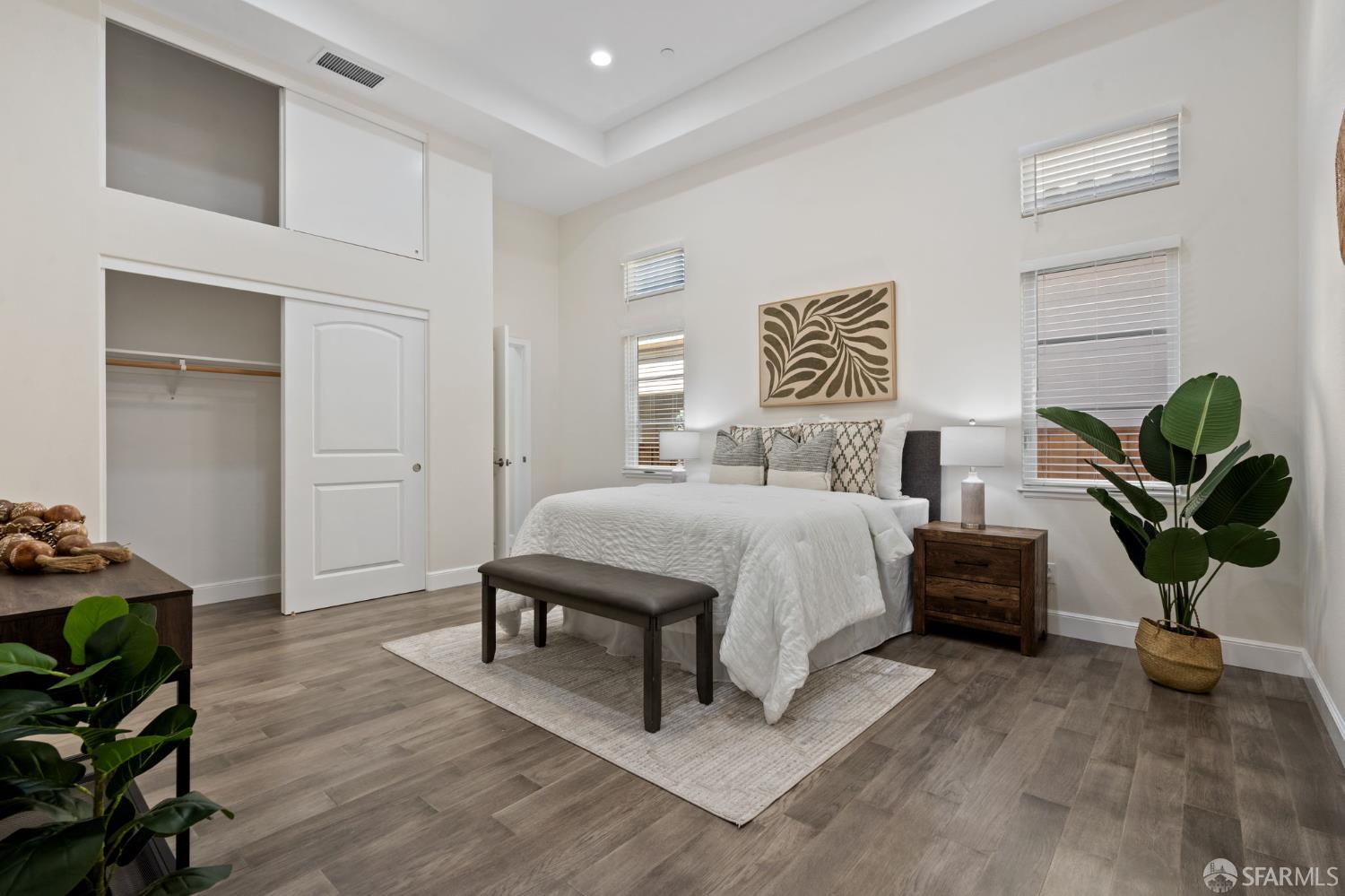 42119 Vinha Way Fremont, CA 94539 - Photo 17 of 43 a bedroom with a bed potted plants with the wooden floor