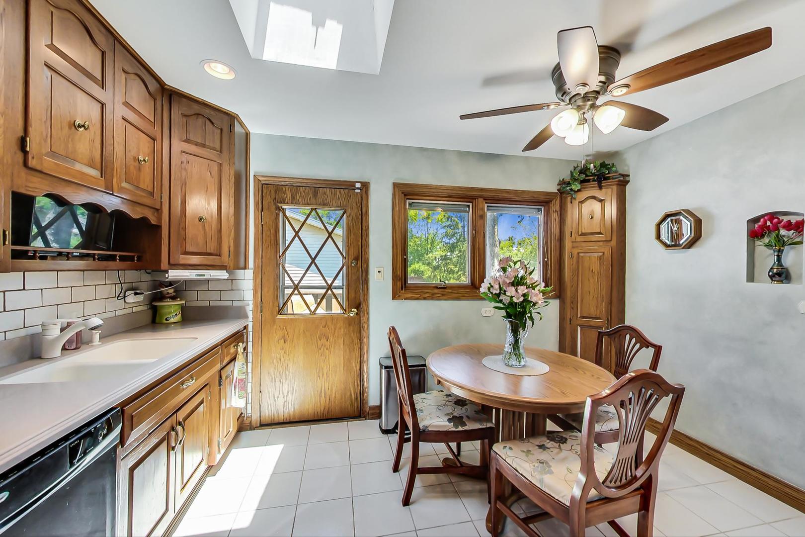 1715 Fremont Road Hoffman Estates, IL 60169 - Photo 14 of 59 a kitchen with a table chairs appliances and cabinets
