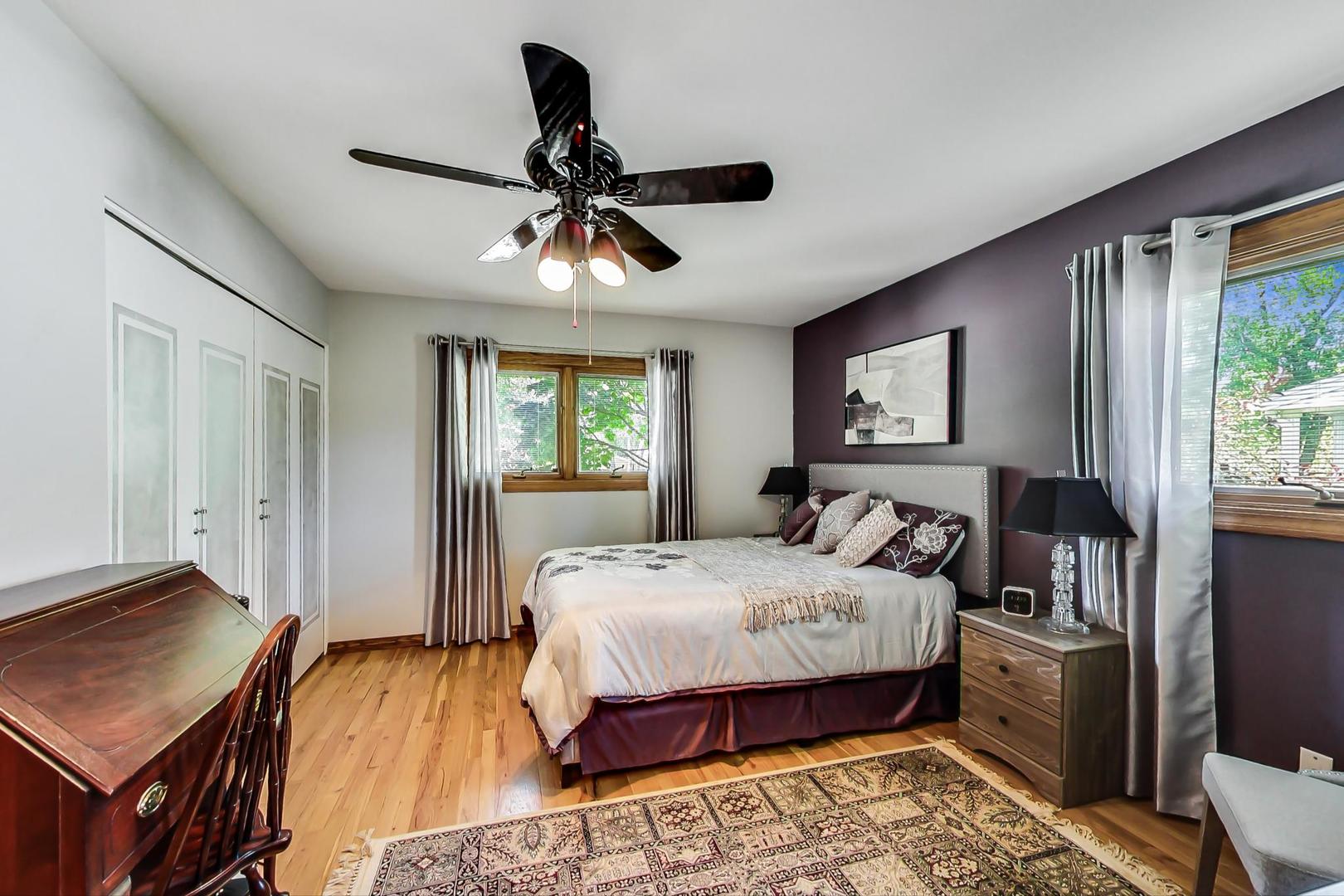 1715 Fremont Road Hoffman Estates, IL 60169 - Photo 16 of 59 a bedroom with a bed and a chandelier
