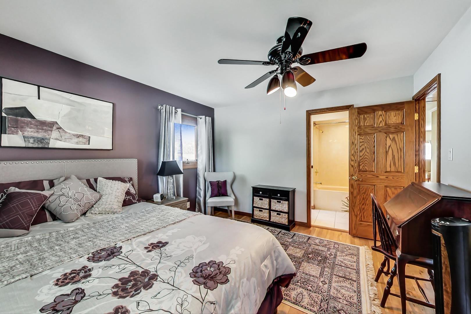 1715 Fremont Road Hoffman Estates, IL 60169 - Photo 17 of 59 a bedroom with a bed and a chandelier