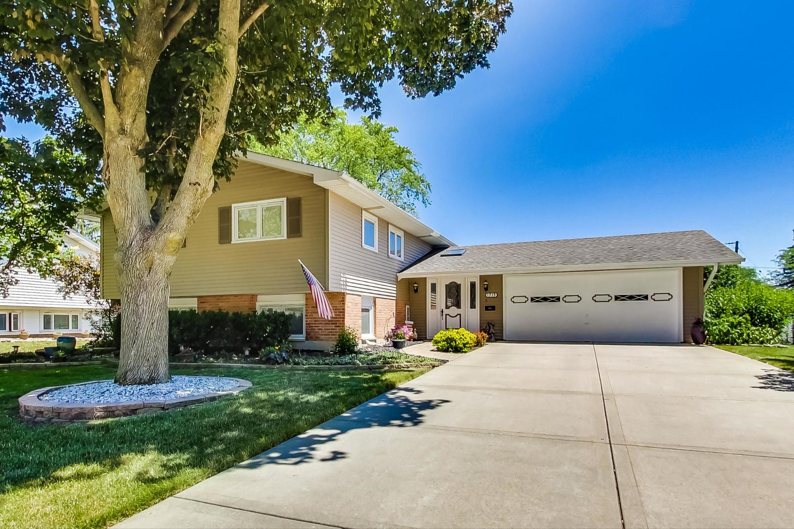 1715 Fremont Road Hoffman Estates, IL 60169 - Photo 2 of 59 a front view of a house with a yard and garage