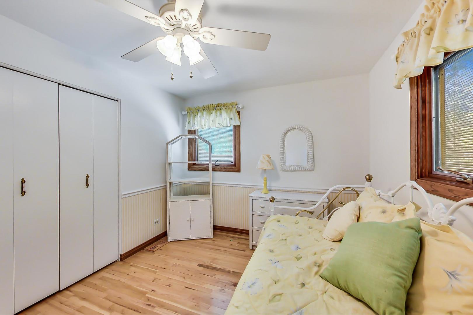 1715 Fremont Road Hoffman Estates, IL 60169 - Photo 22 of 59 a bedroom with a bed and a chandelier