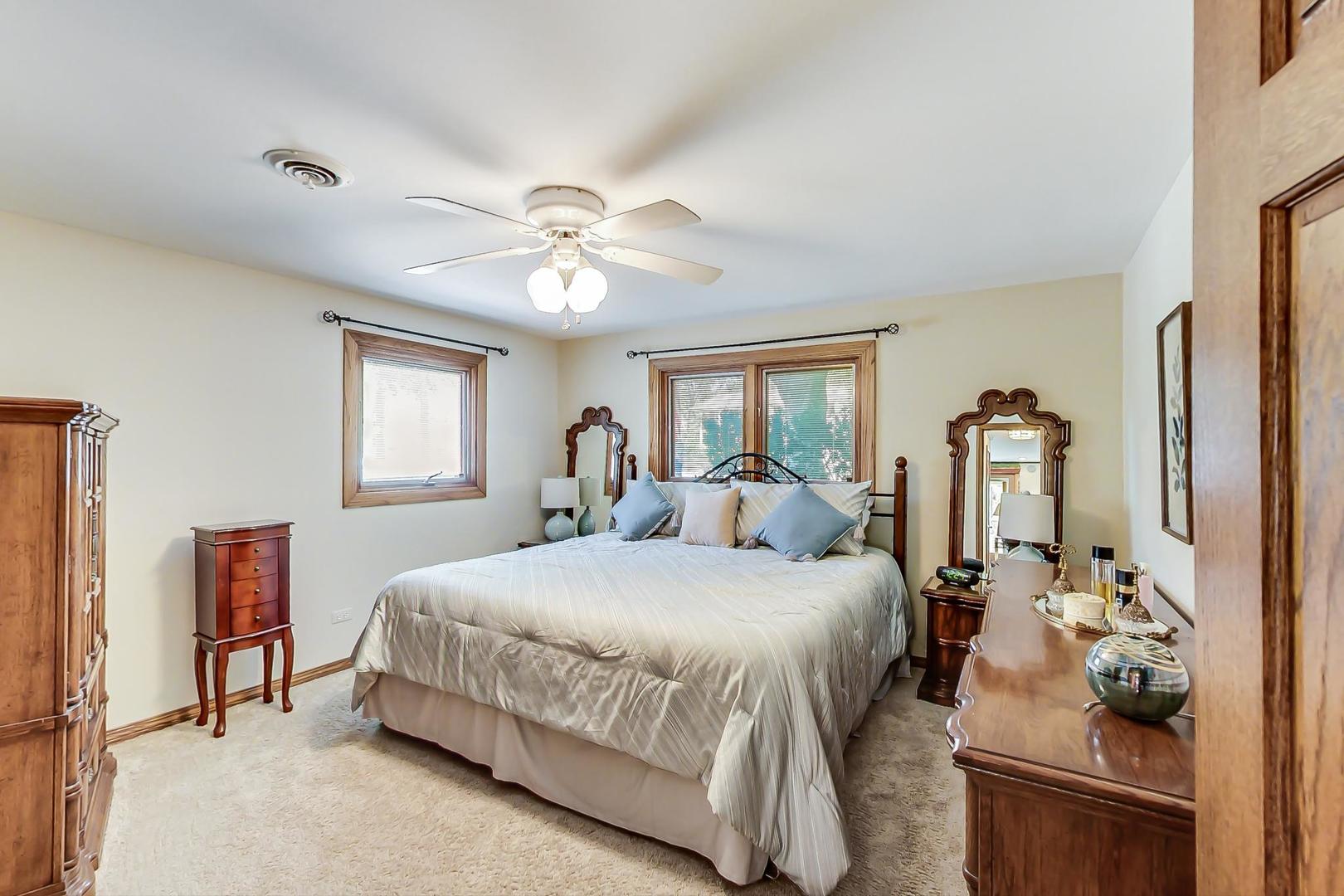 1715 Fremont Road Hoffman Estates, IL 60169 - Photo 30 of 59 a bedroom with a bed and ceiling fan