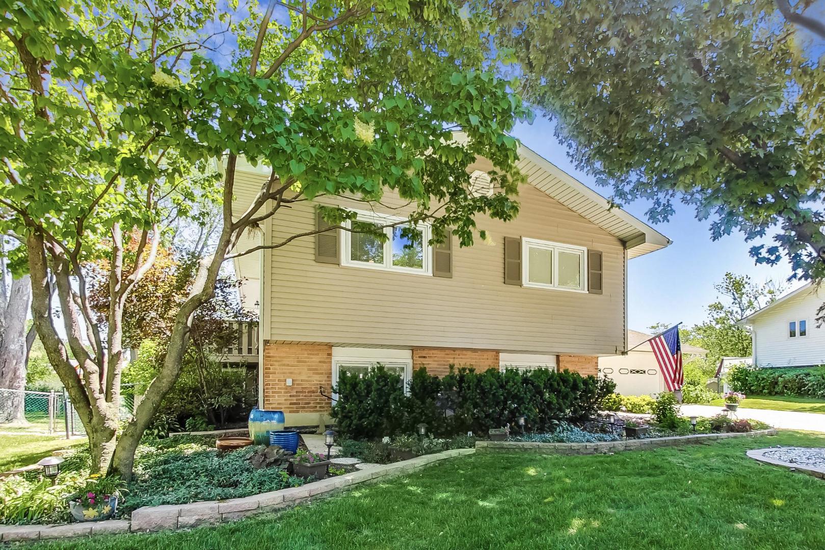 1715 Fremont Road Hoffman Estates, IL 60169 - Photo 3 of 59 a front view of a house with a yard and trees