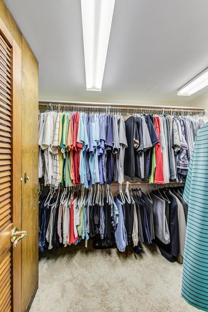 1715 Fremont Road Hoffman Estates, IL 60169 - Photo 33 of 59 a view of walk in closet with clothes and shoes