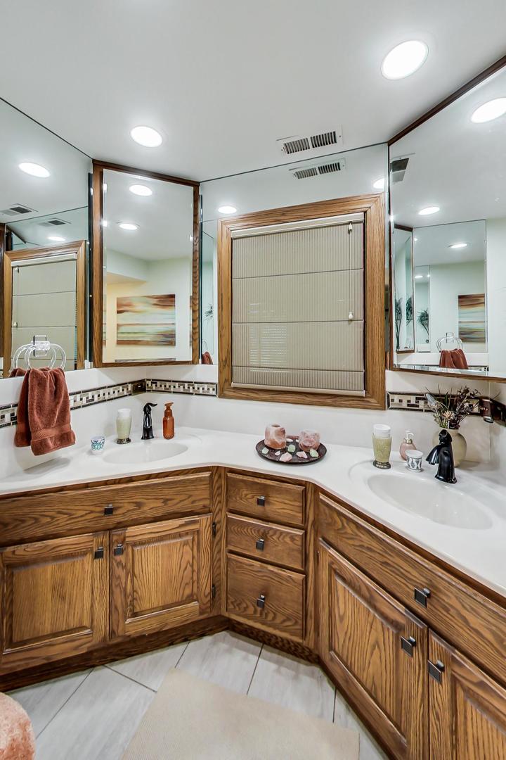 1715 Fremont Road Hoffman Estates, IL 60169 - Photo 37 of 59 a bathroom with a sink double vanity granite and a mirror