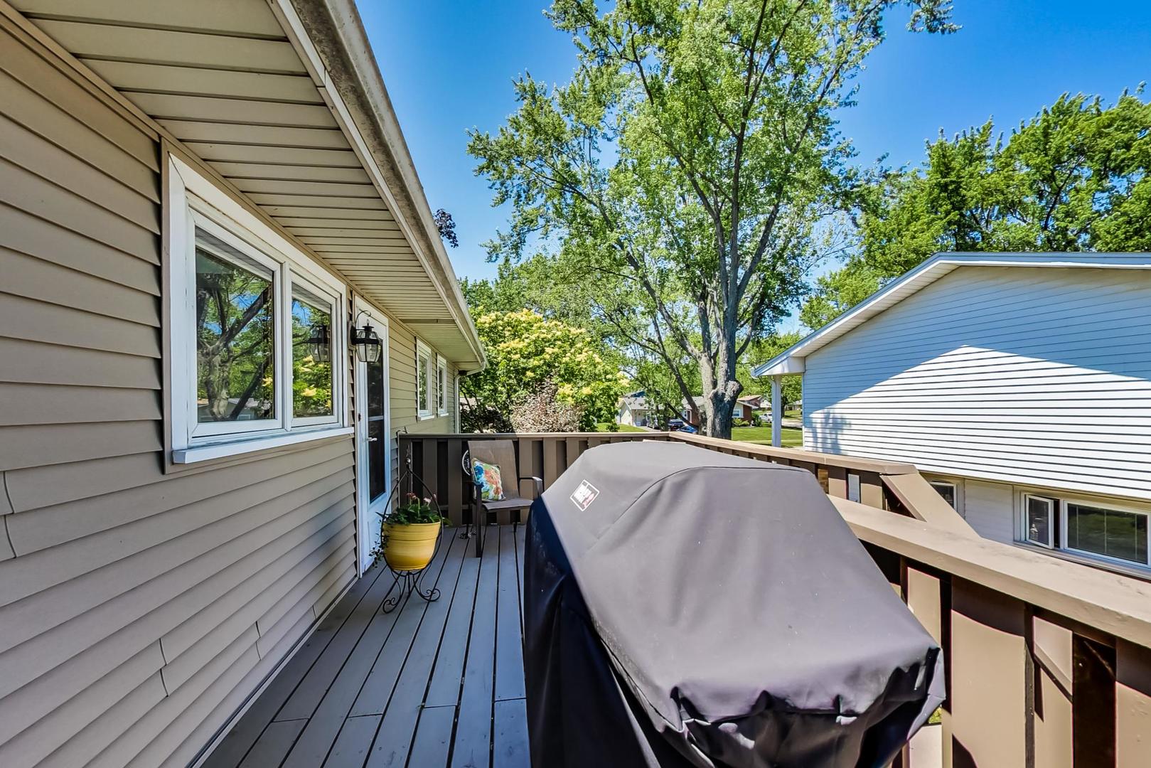 1715 Fremont Road Hoffman Estates, IL 60169 - Photo 44 of 59 a view of a roof deck with table and chairs and wooden floor