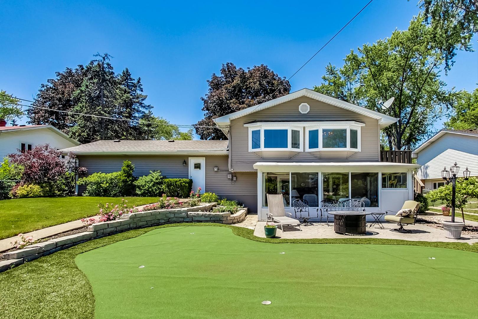 1715 Fremont Road Hoffman Estates, IL 60169 - Photo 46 of 59 a front view of a house with a garden and swimming pool
