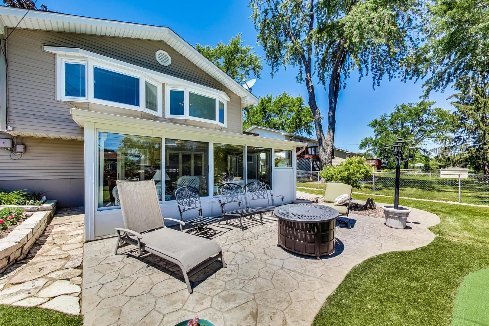 1715 Fremont Road Hoffman Estates, IL 60169 - Photo 48 of 59 a view of a patio with table and chairs potted plants and a large tree