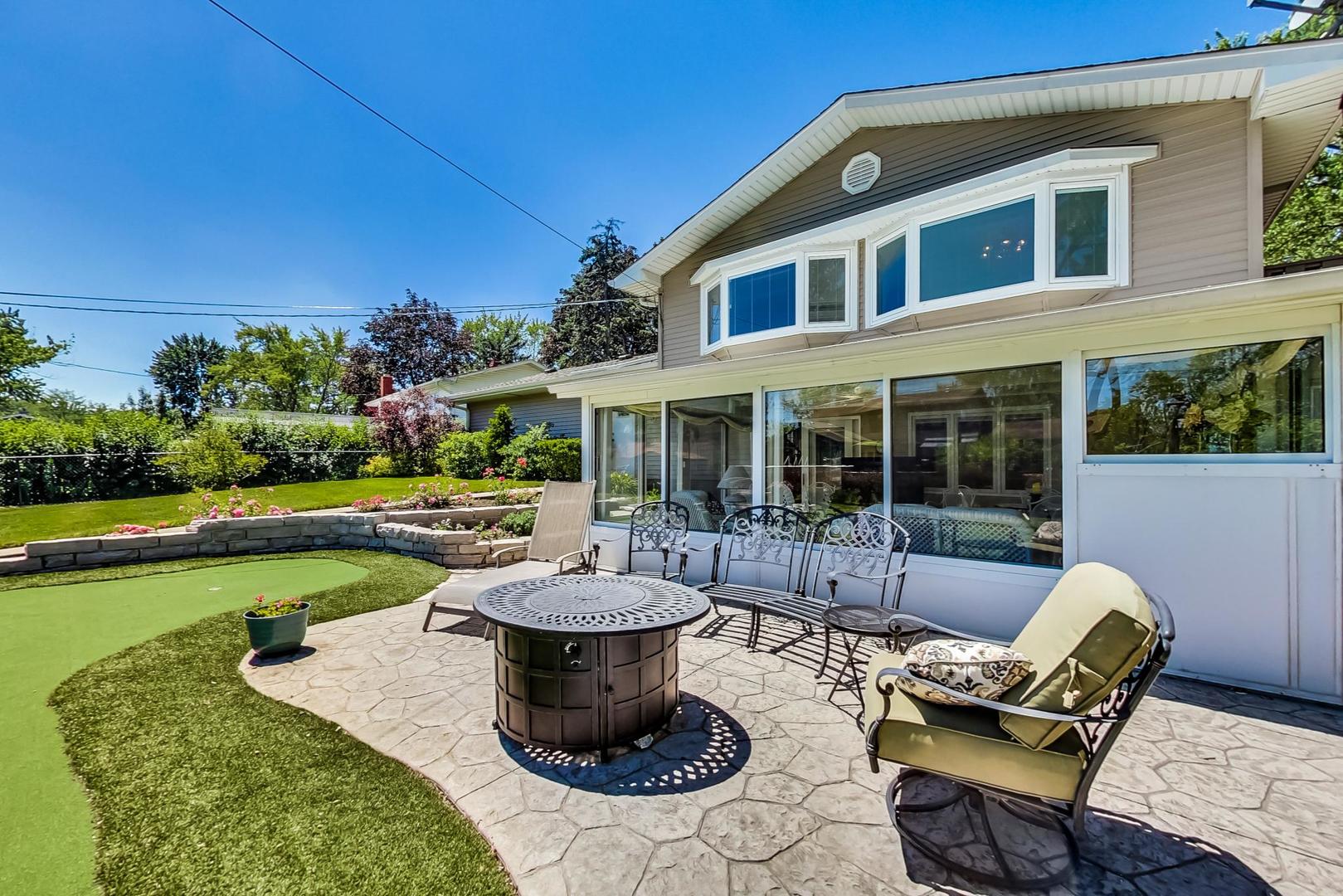 1715 Fremont Road Hoffman Estates, IL 60169 - Photo 50 of 59 a view of a patio with dining table and chairs with plants