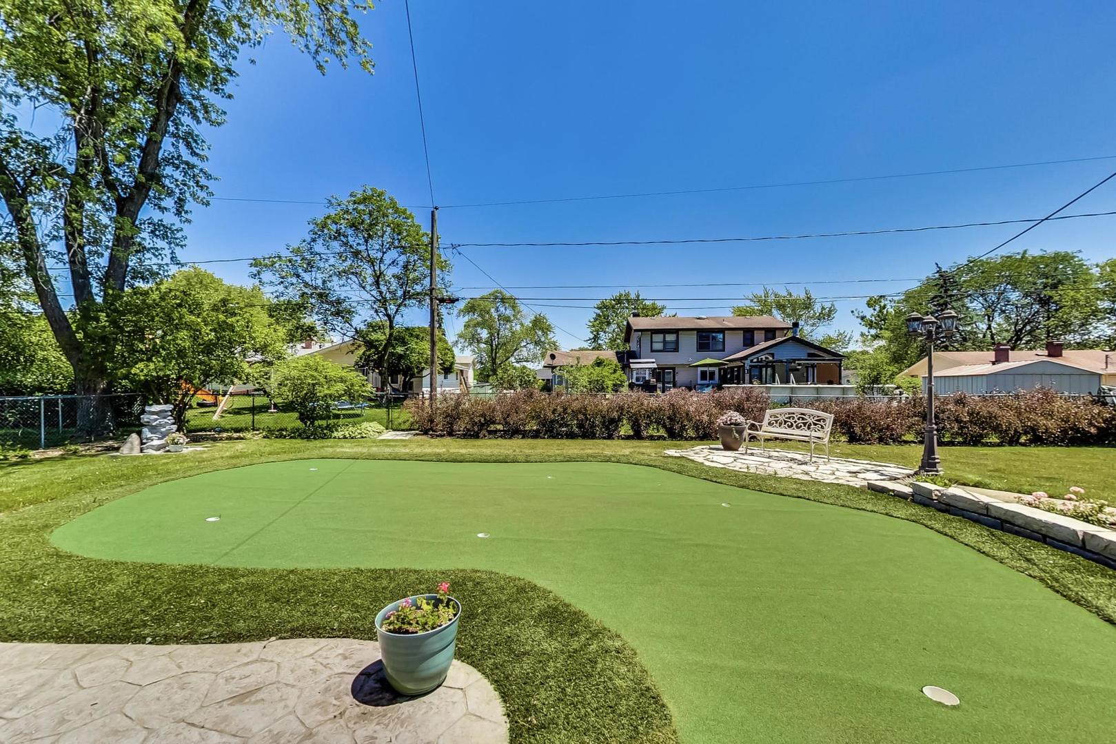 1715 Fremont Road Hoffman Estates, IL 60169 - Photo 53 of 59 a front view of a house with swimming pool outdoor seating and yard