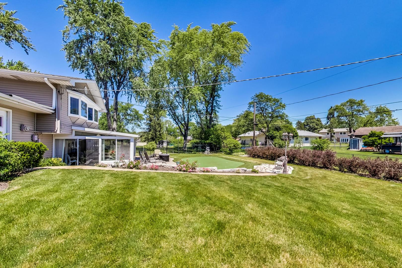 1715 Fremont Road Hoffman Estates, IL 60169 - Photo 55 of 59 a view of a house with a big yard potted plants and large tree